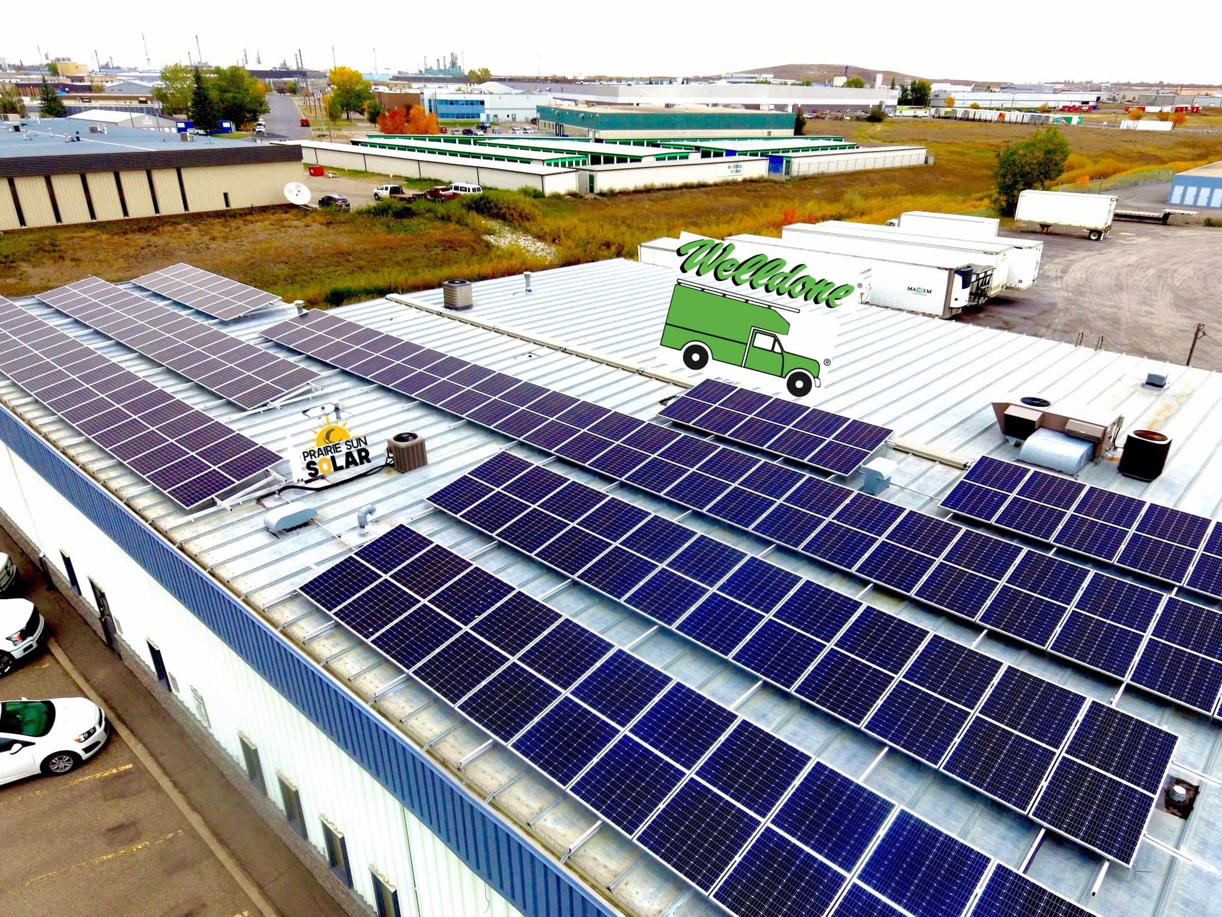 Aerial view of the WellDone Mechanical building in Regina with its rooftop solar array and a WellDone service truck in the yard
