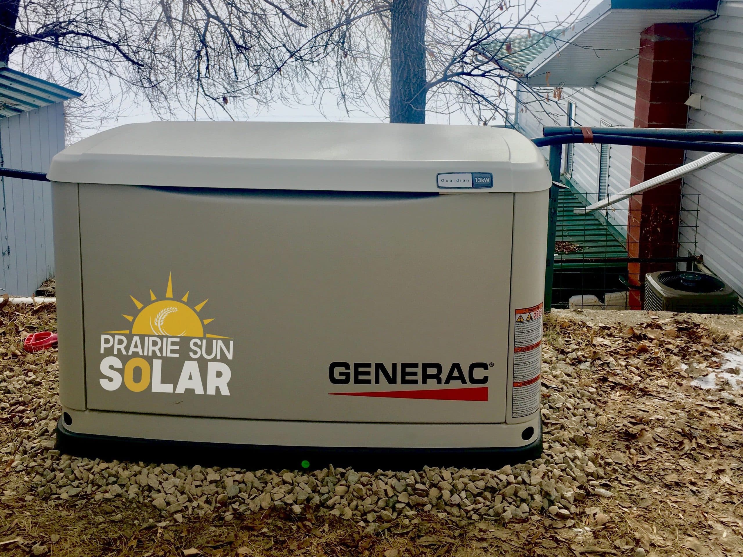 Generac Guardian 13 kW standby generator installed by Prairie Sun Solar at a lake property, with the frozen lake behind it