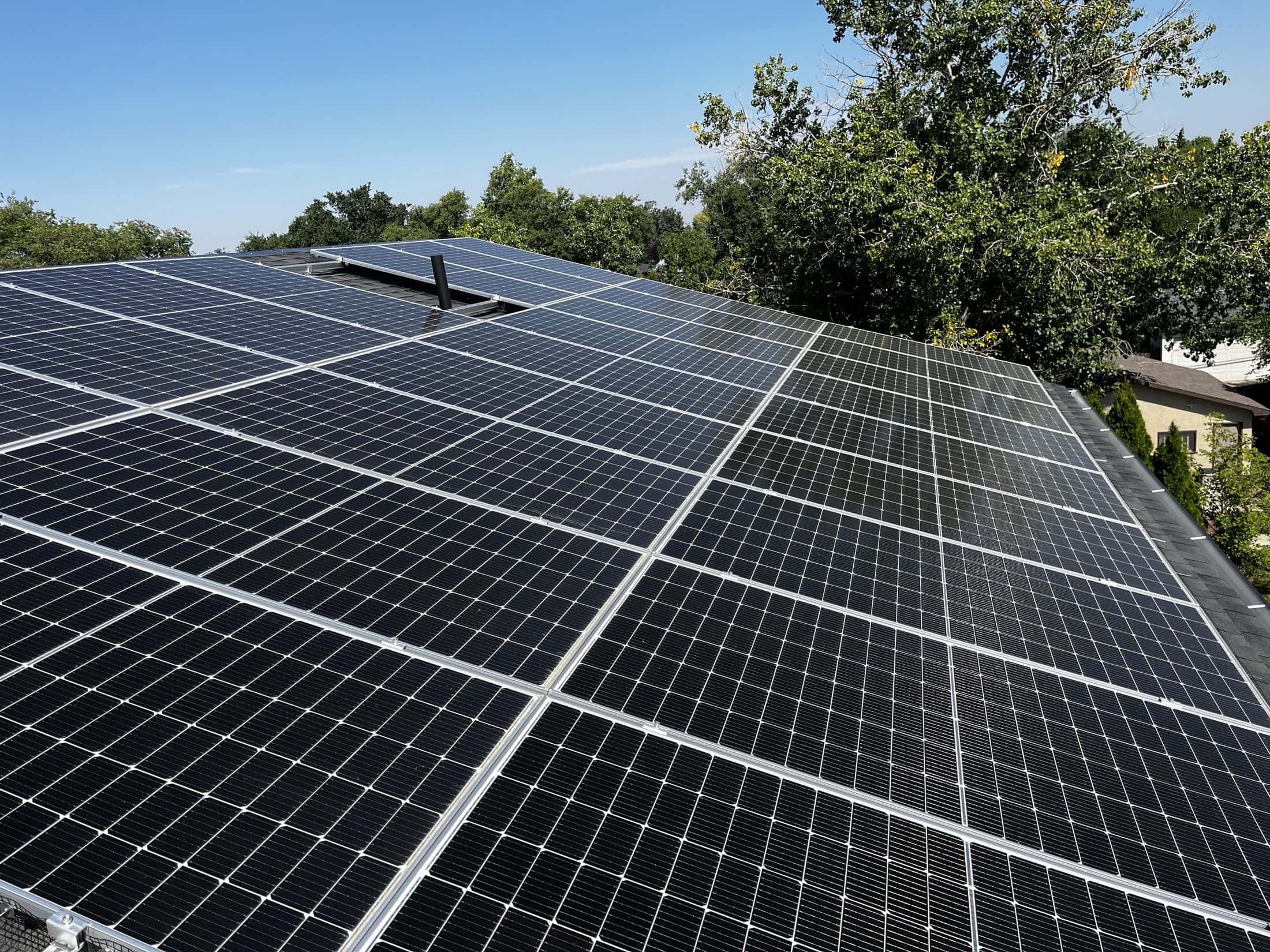 Rooftop solar array on a Regina home on Kelly Avenue, seen along the panels on a clear summer day